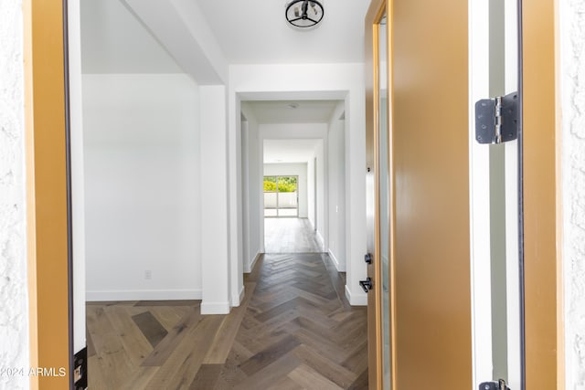 hall featuring baseboards