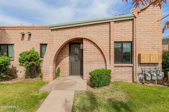 view of front of property with brick siding and a front yard