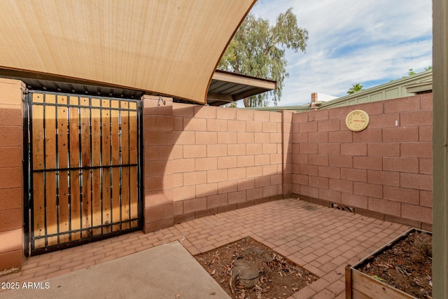 view of patio / terrace featuring fence and a gate