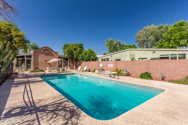 pool featuring a patio and fence