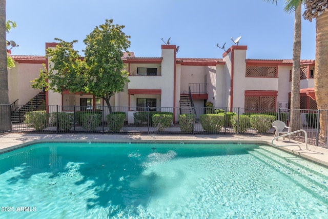 pool with fence and stairs