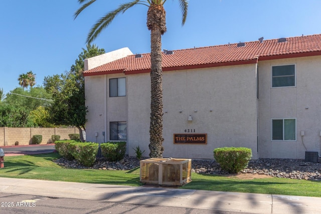 exterior space featuring central AC and fence