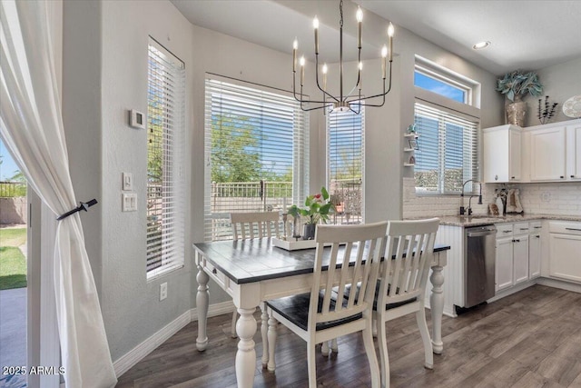 dining room featuring baseboards, a textured wall, an inviting chandelier, and dark wood finished floors