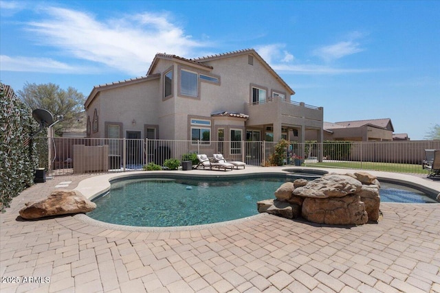 view of pool with a fenced in pool, an in ground hot tub, fence, and a patio area