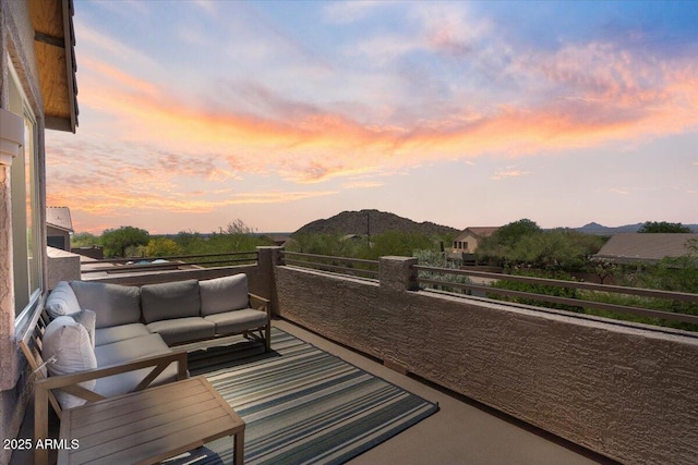 balcony with an outdoor living space and a mountain view