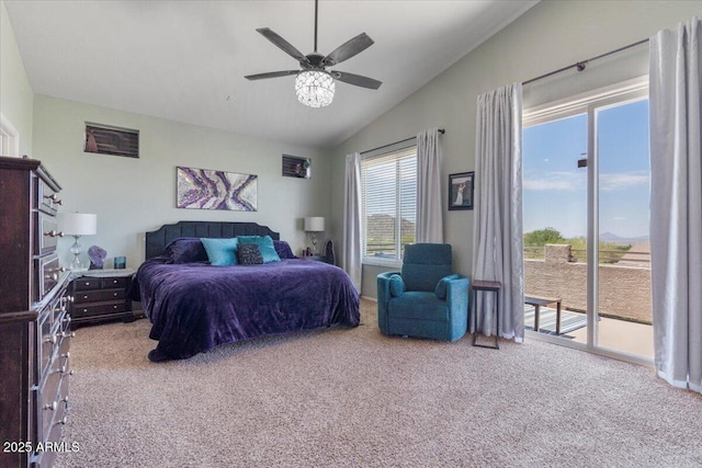 carpeted bedroom featuring a ceiling fan, vaulted ceiling, and access to exterior