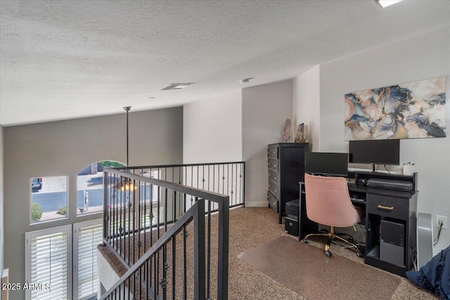 office space with baseboards, a textured ceiling, and carpet