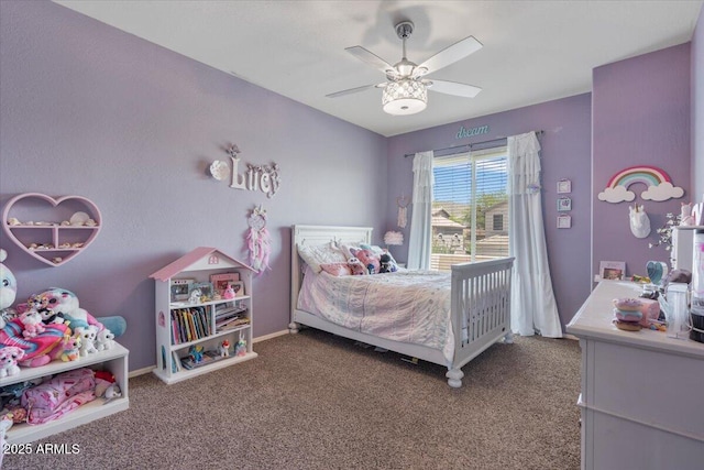 carpeted bedroom featuring baseboards and a ceiling fan