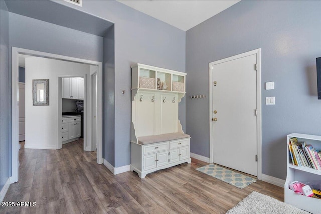 mudroom featuring baseboards and wood finished floors