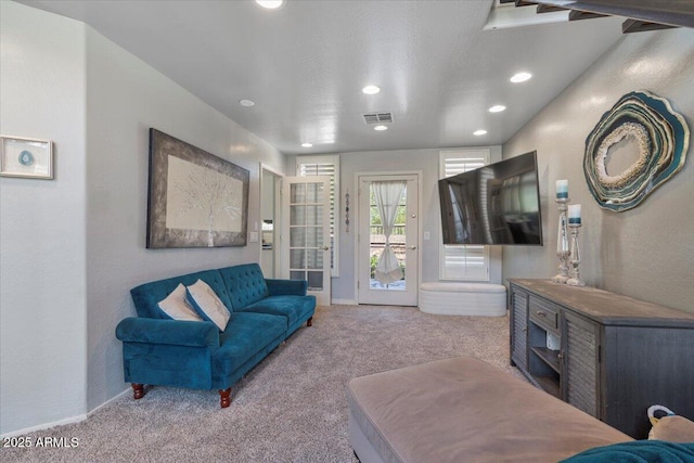 living room featuring carpet flooring, recessed lighting, baseboards, and visible vents