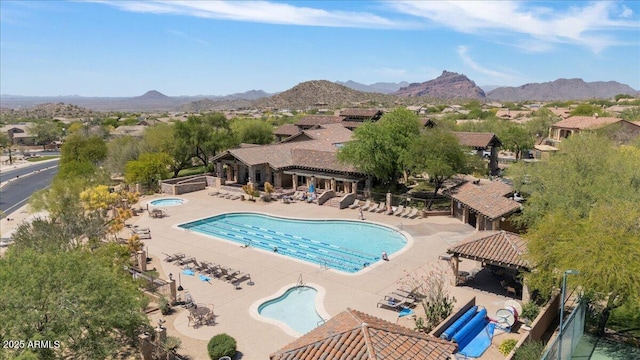 community pool featuring a pergola, a mountain view, a community hot tub, and a patio area