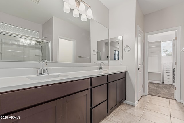 17376 W Via De Luna Dr, Surprise, AZ 85387 - bathroom with double vanity, tile patterned floors, a shower stall, and a sink