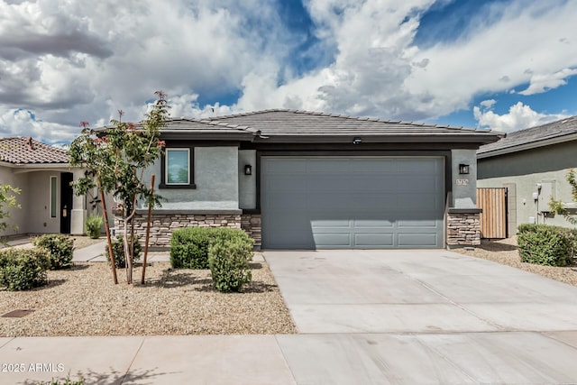 17376 W Via De Luna Dr, Surprise, AZ 85387 - prairie-style home with driveway, a tile roof, a garage, stone siding, and stucco siding