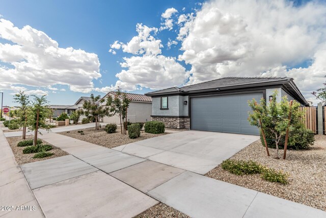 17376 W Via De Luna Dr, Surprise, AZ 85387 - view of front facade featuring a garage, stone siding, stucco siding, a tiled roof, and driveway