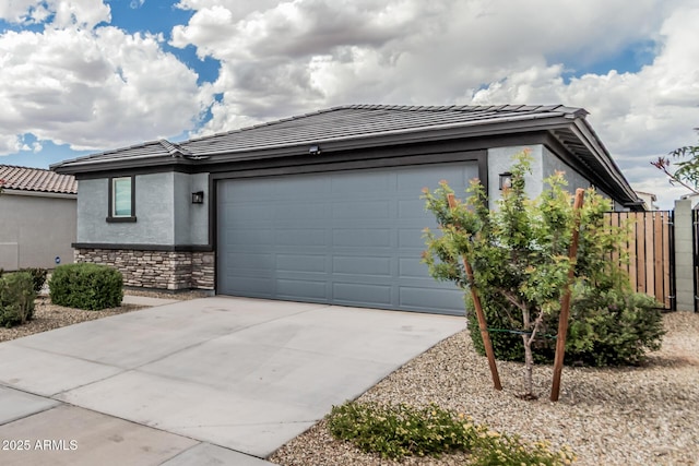 17376 W Via De Luna Dr, Surprise, AZ 85387 - view of front of property featuring a tiled roof, a garage, driveway, and stucco siding