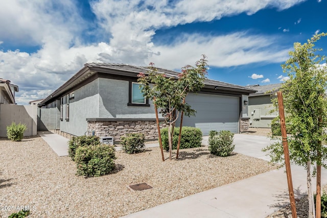 17376 W Via De Luna Dr, Surprise, AZ 85387 - view of front of property featuring concrete driveway, fence, stone siding, and stucco siding