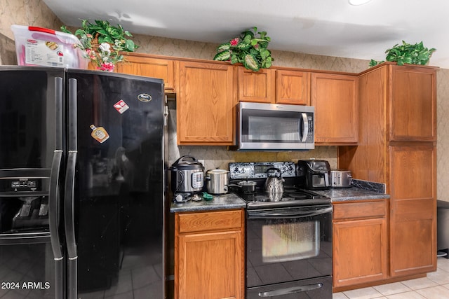 kitchen featuring black appliances and light tile patterned floors