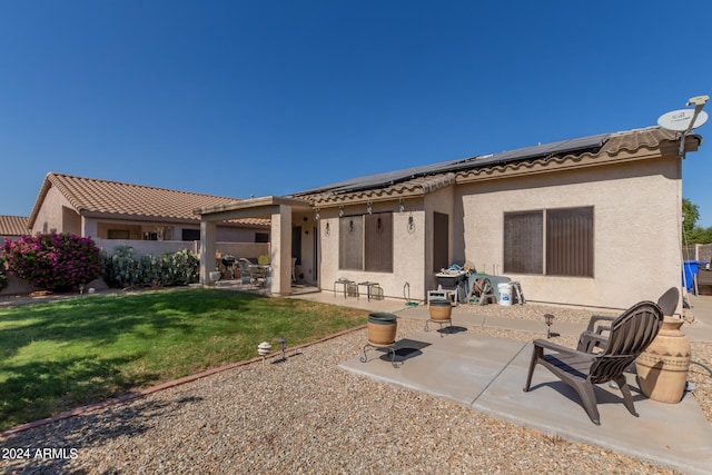 back of house featuring a yard and a patio