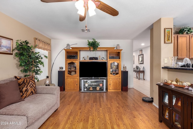 living room with hardwood / wood-style flooring and ceiling fan