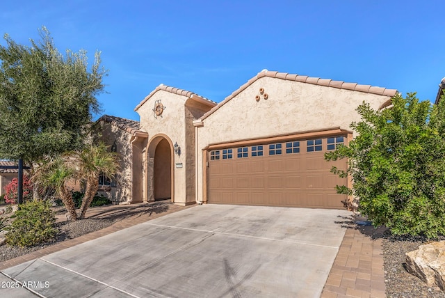 mediterranean / spanish-style home featuring a garage