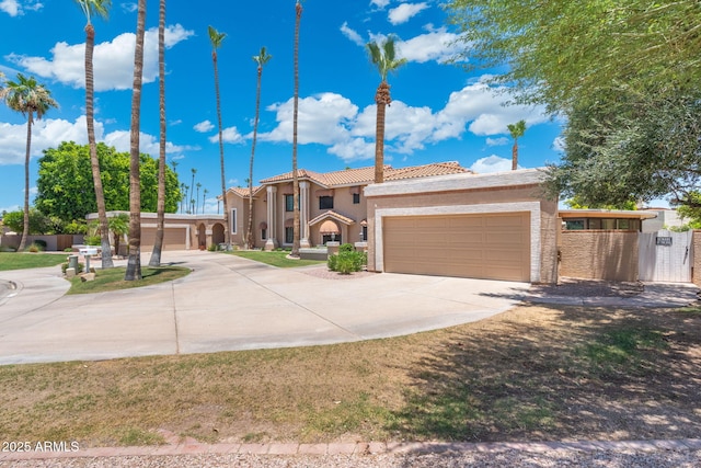 1338 E Greenway Cir, Mesa, AZ 85203 - mediterranean / spanish-style home with concrete driveway, a tile roof, stucco siding, and an attached garage