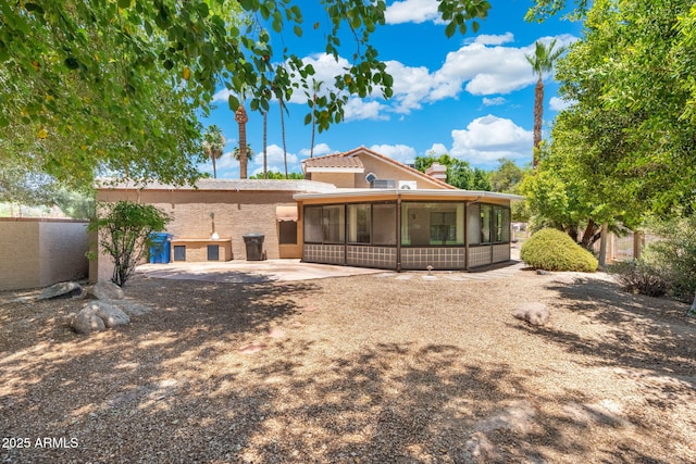 1338 E Greenway Cir, Mesa, AZ 85203 - back of house with a sunroom, stucco siding, a patio, and a chimney