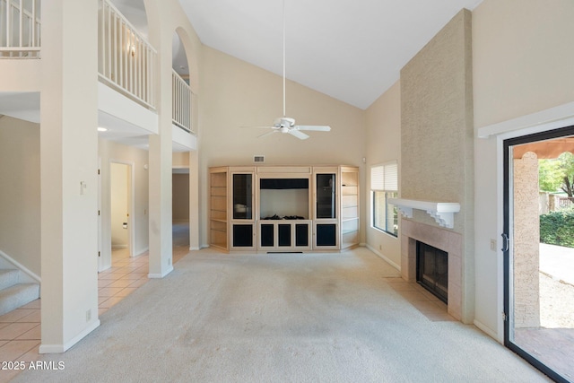 1338 E Greenway Cir, Mesa, AZ 85203 - unfurnished living room with carpet, a fireplace, a ceiling fan, high vaulted ceiling, and tile patterned flooring