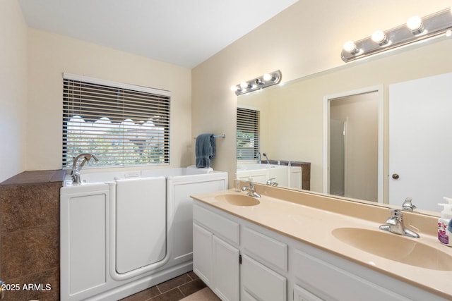 1338 E Greenway Cir, Mesa, AZ 85203 - bathroom with a garden tub, double vanity, and tile patterned floors