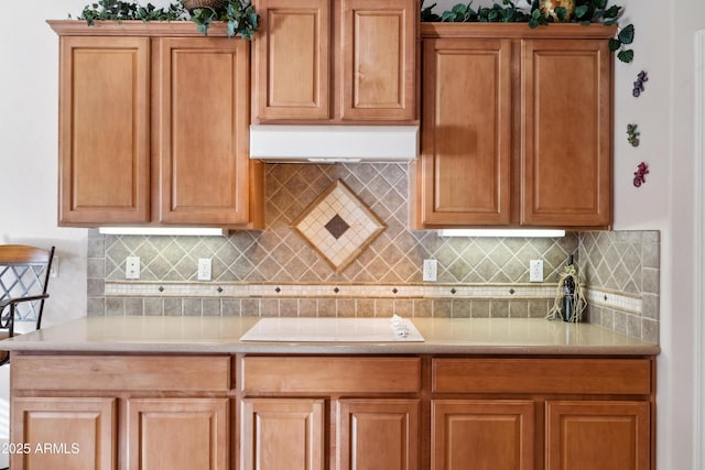 kitchen with cooktop and decorative backsplash