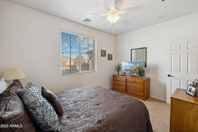 bedroom with ceiling fan and light carpet