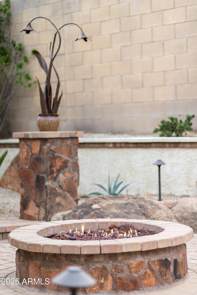 exterior details featuring an outdoor fire pit