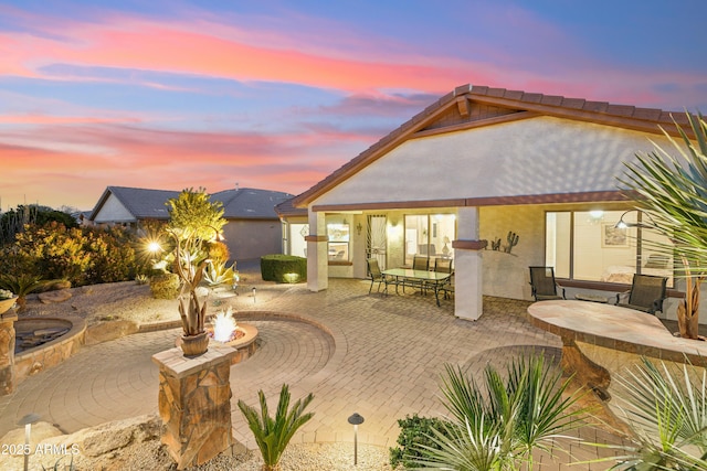 patio terrace at dusk with a fire pit