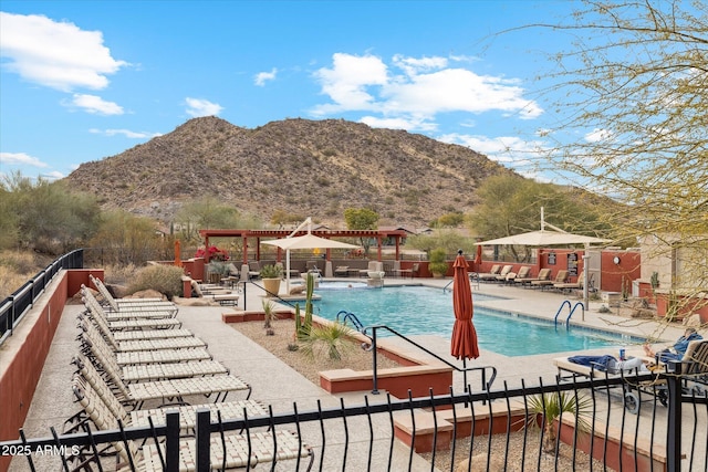 view of swimming pool with a patio and a mountain view