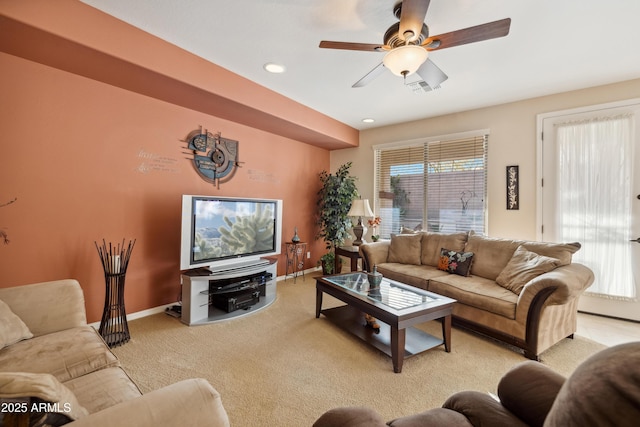 carpeted living room featuring ceiling fan