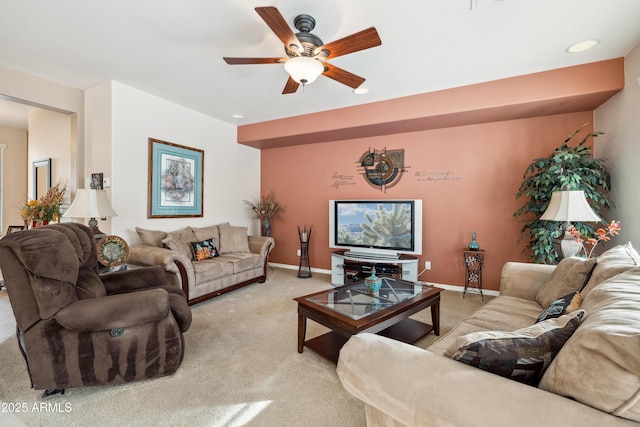 carpeted living room with ceiling fan