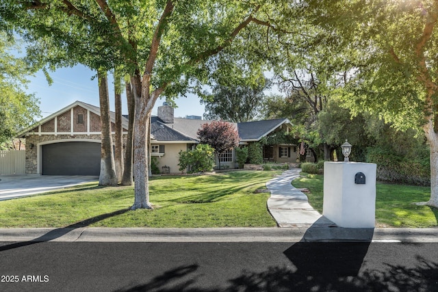 5112 N 41st St, Phoenix, AZ 85018 - view of front of property featuring an attached garage, a front lawn, a chimney, driveway, and stone siding