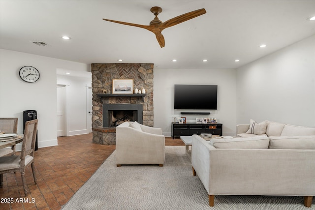 5112 N 41st St, Phoenix, AZ 85018 - living room with brick floors, a ceiling fan, recessed lighting, a fireplace, and baseboards