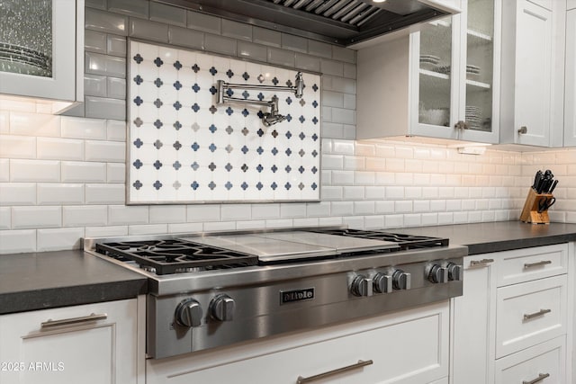 5112 N 41st St, Phoenix, AZ 85018 - kitchen featuring stainless steel gas stovetop, decorative backsplash, white cabinetry, and glass insert cabinets