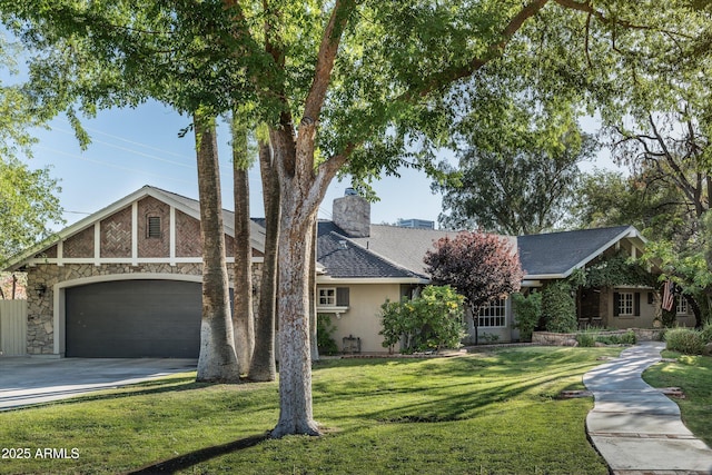 5112 N 41st St, Phoenix, AZ 85018 - view of front facade with concrete driveway, a garage, a front yard, a chimney, and stone siding