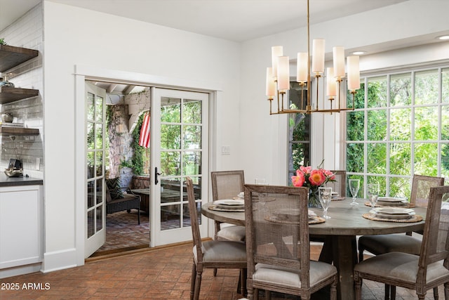 5112 N 41st St, Phoenix, AZ 85018 - dining space featuring brick floors, plenty of natural light, and a chandelier
