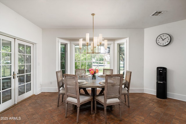 5112 N 41st St, Phoenix, AZ 85018 - dining room featuring brick flooring, baseboards, and plenty of natural light