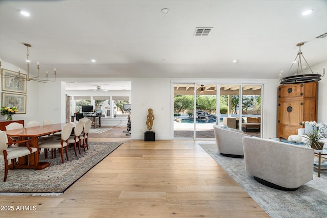 5112 N 41st St, Phoenix, AZ 85018 - dining room featuring light wood-style flooring, recessed lighting, a ceiling fan, a chandelier, and baseboards