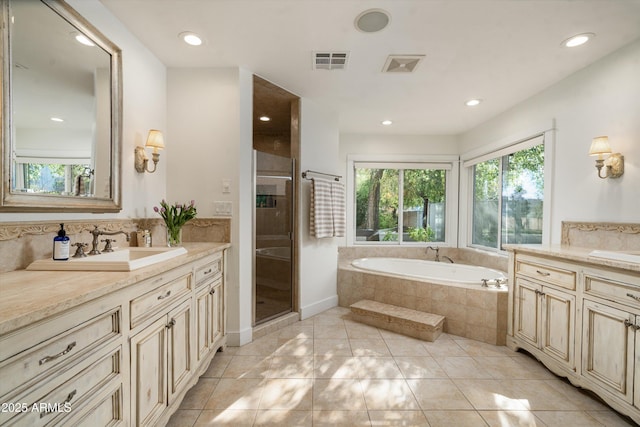 5112 N 41st St, Phoenix, AZ 85018 - bathroom featuring two vanities, a garden tub, a stall shower, recessed lighting, and backsplash