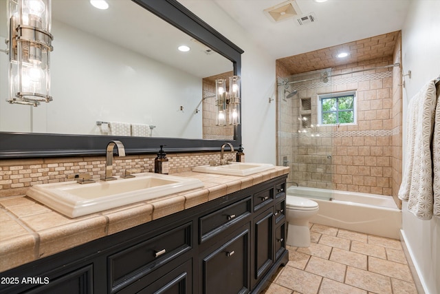 5112 N 41st St, Phoenix, AZ 85018 - bathroom featuring toilet, double vanity, bathtub / shower combination, tasteful backsplash, and recessed lighting