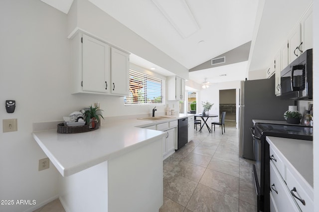 kitchen featuring white cabinets, dishwasher, a sink, lofted ceiling, and black electric range oven