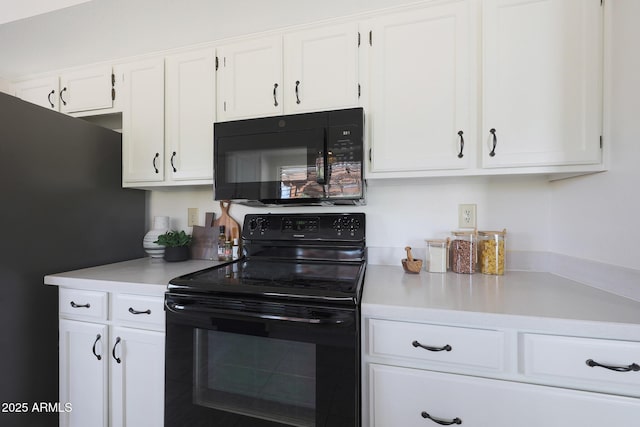 kitchen with black appliances, white cabinetry, and light countertops