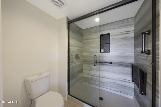 bathroom with visible vents, a stall shower, toilet, and tile patterned flooring