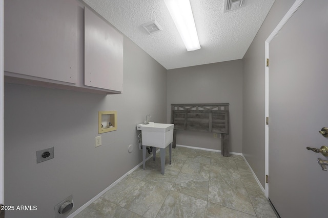 clothes washing area featuring hookup for a washing machine, electric dryer hookup, visible vents, and cabinet space