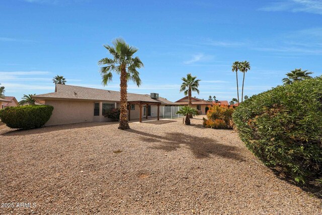 rear view of property with fence and a patio area