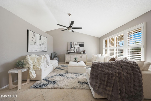living area featuring tile patterned floors, ceiling fan, vaulted ceiling, and baseboards